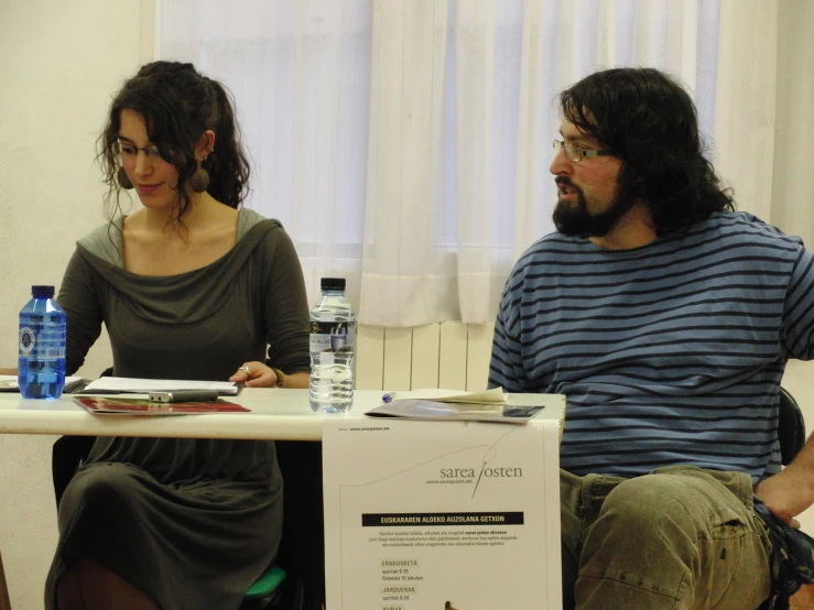 a man sitting next to a woman at a table