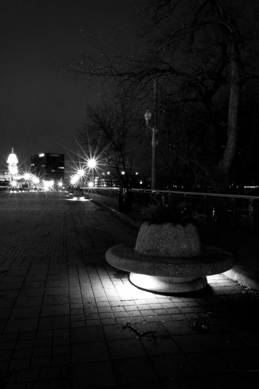 night scene with light shining down on brick sidewalk