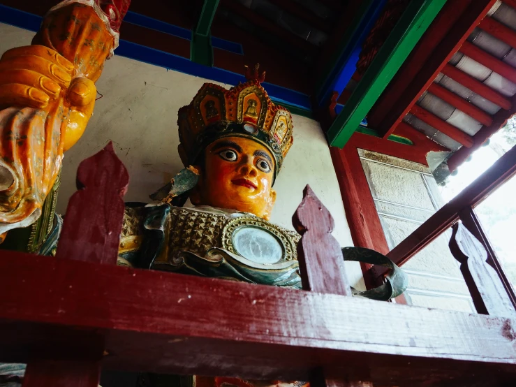 statue of a child wearing an ornate crown surrounded by wooden stairs