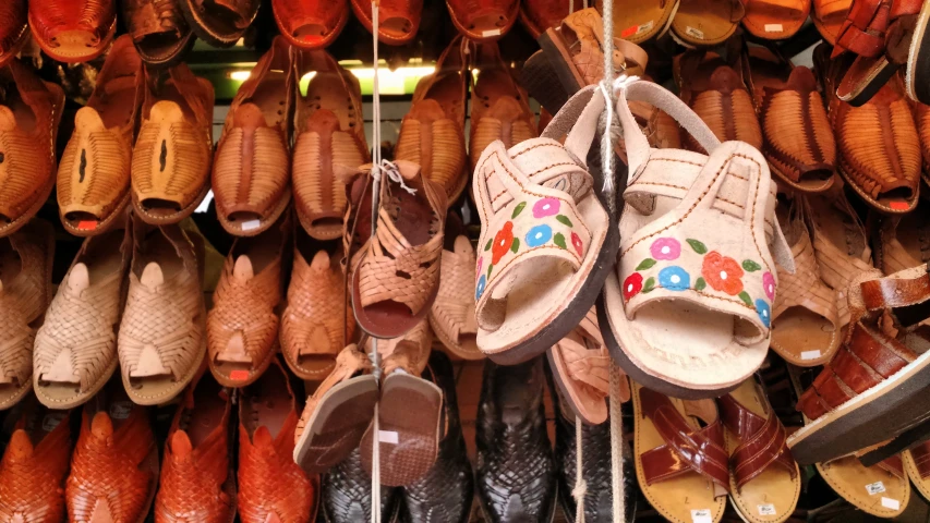 rows of shoes sitting on racks with their top and bottom painted colors