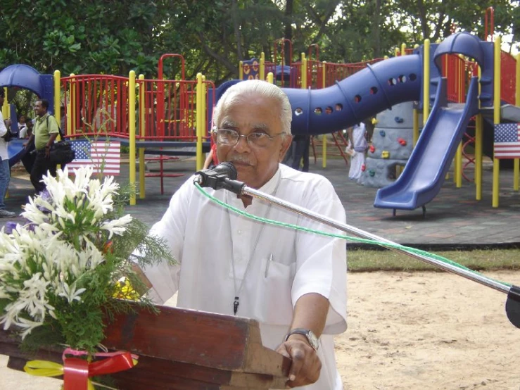 a man standing at a podium with a microphone