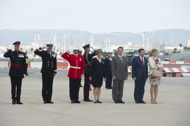 military personnel standing next to men dressed in uniform