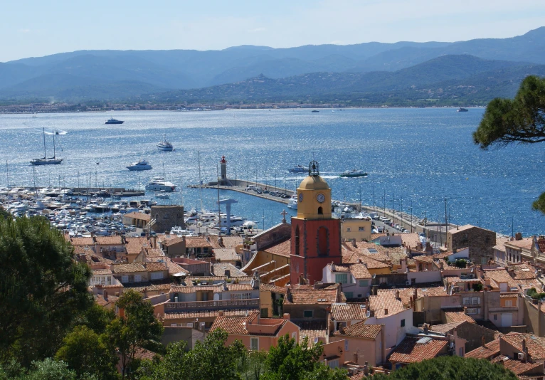 a town surrounded by the ocean and many boats in the water