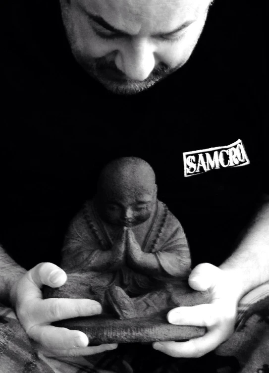 a man reading a book to a baby with one hand