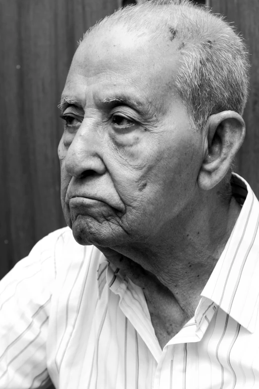 an older man with a torn head looking at the camera