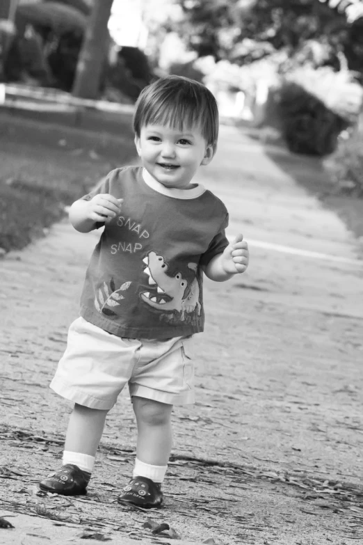 a little boy is standing on the path