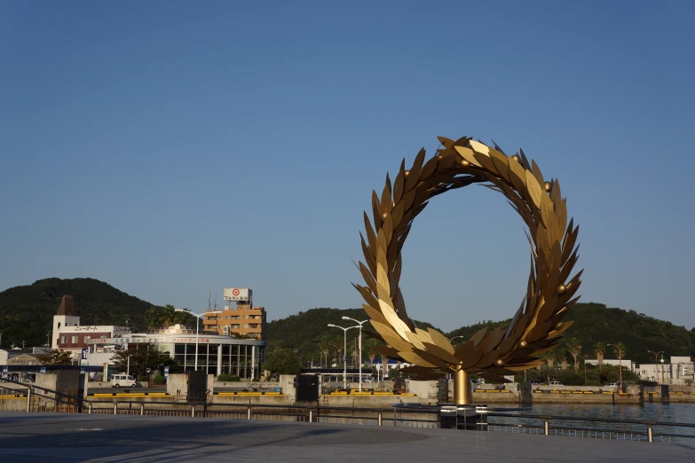 an art piece in a plaza with mountains in the background