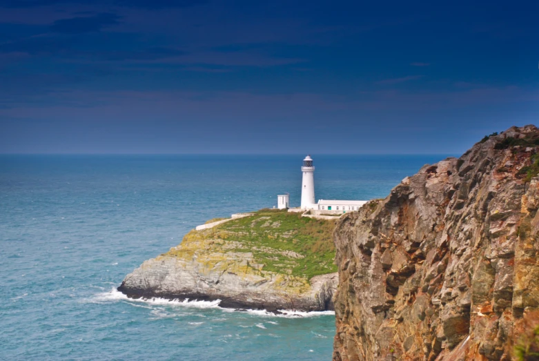 a lighthouse on an island in the middle of ocean