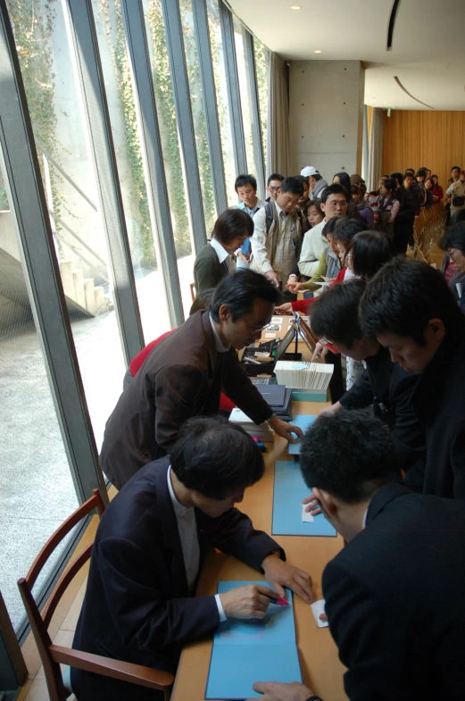 many people are sitting at a large table together