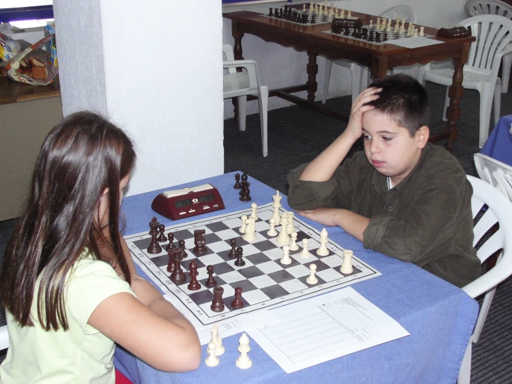 a  and girl playing chess in a restaurant