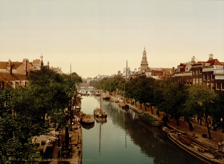 a river with boats sitting next to trees and buildings