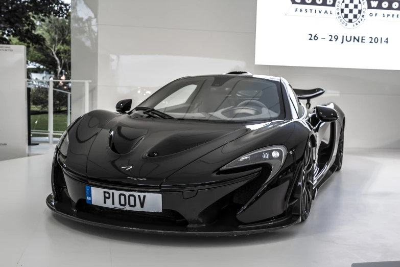 the black sports car is on display in a showroom