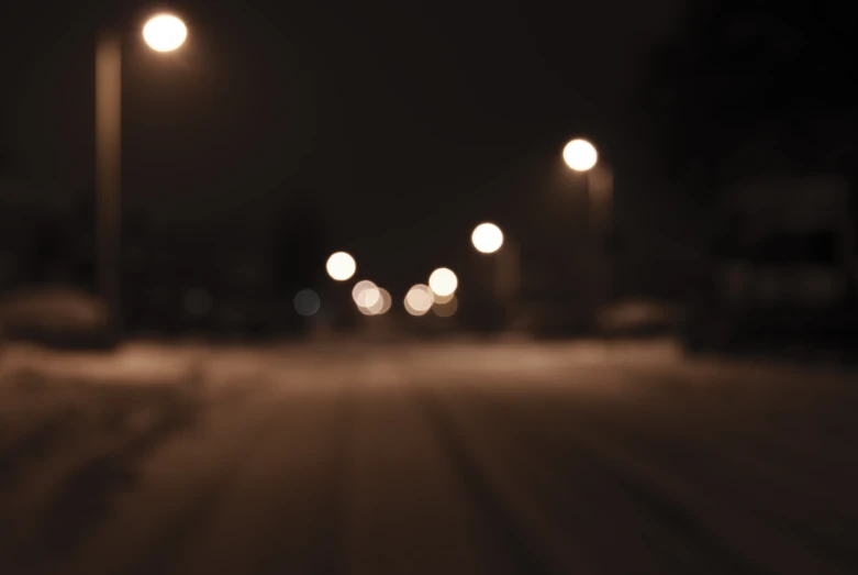 an empty road has multiple streetlights lit up at night