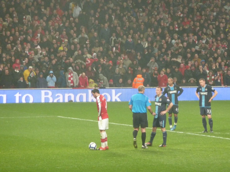 a soccer game between the opposing teams in front of an audience