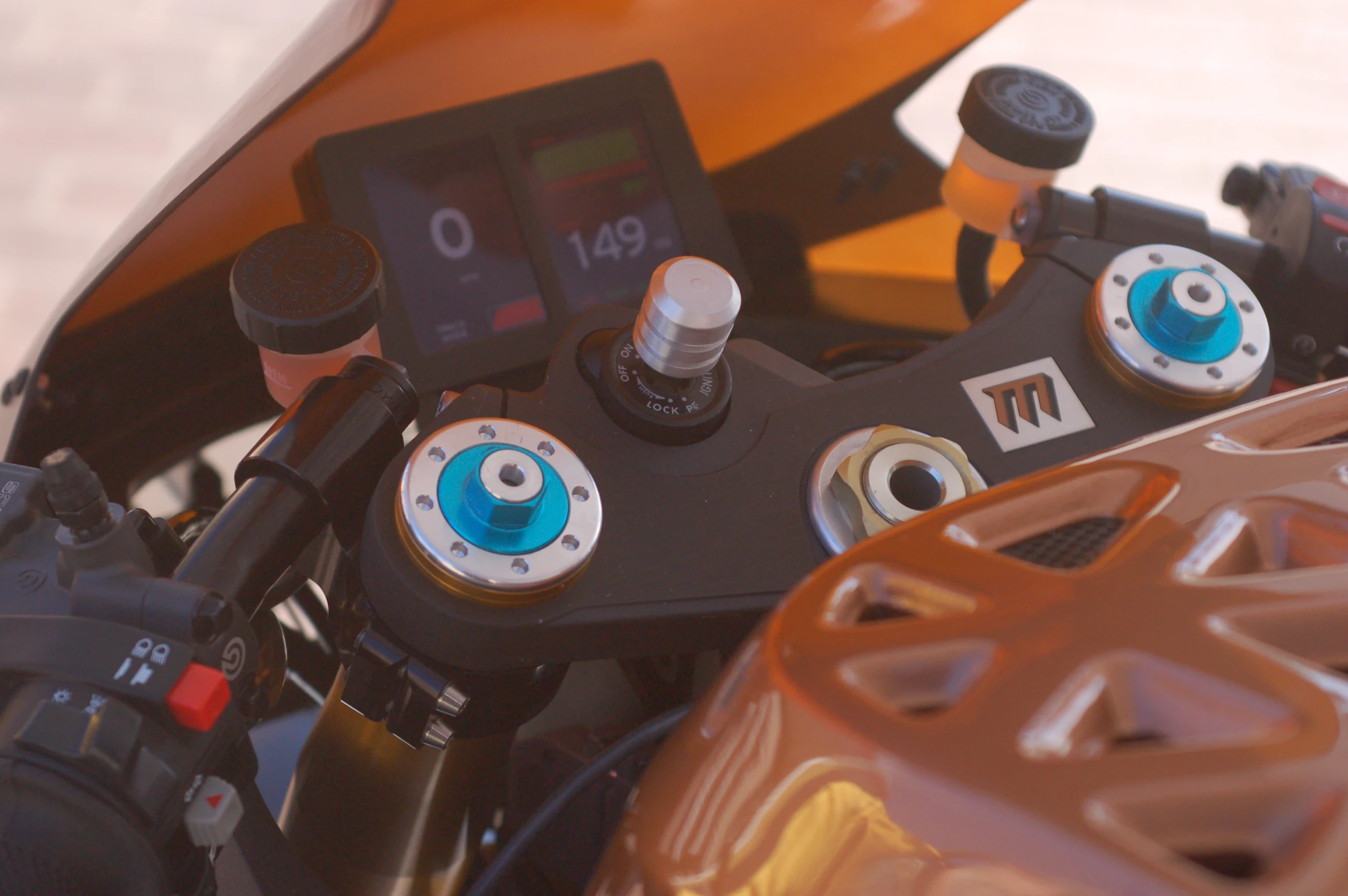 the dashboard and control of a motorcycle with orange rubber pads