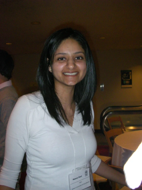 a smiling girl with long black hair at a restaurant