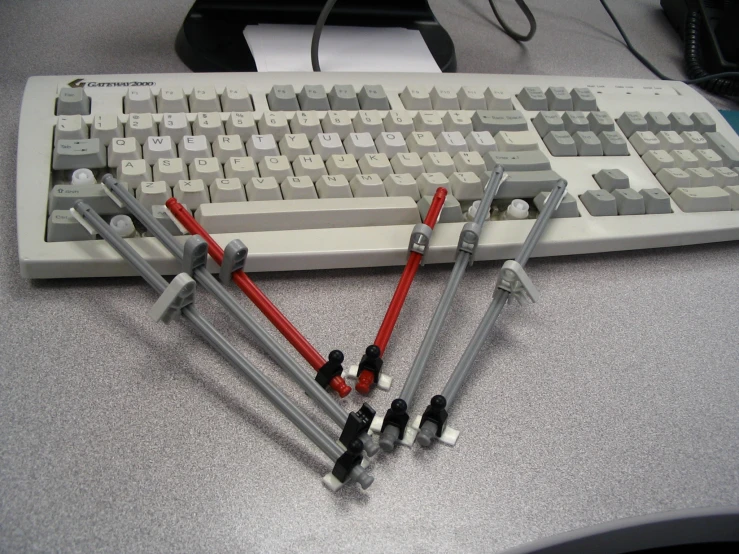 a computer keyboard and several other electronics connected together