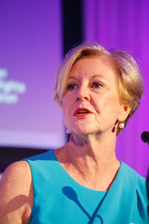 a woman is giving a speech with microphone