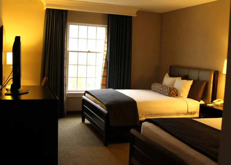 a dark el room with yellow walls and a small bed