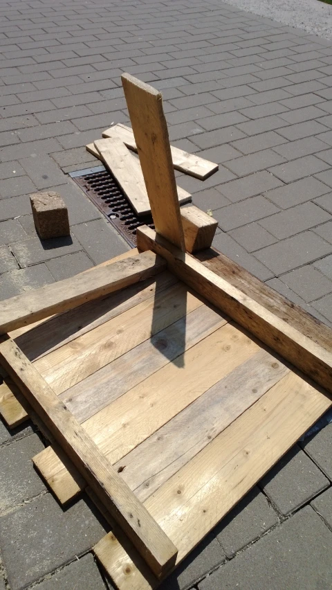 a pile of wood with pieces on the ground