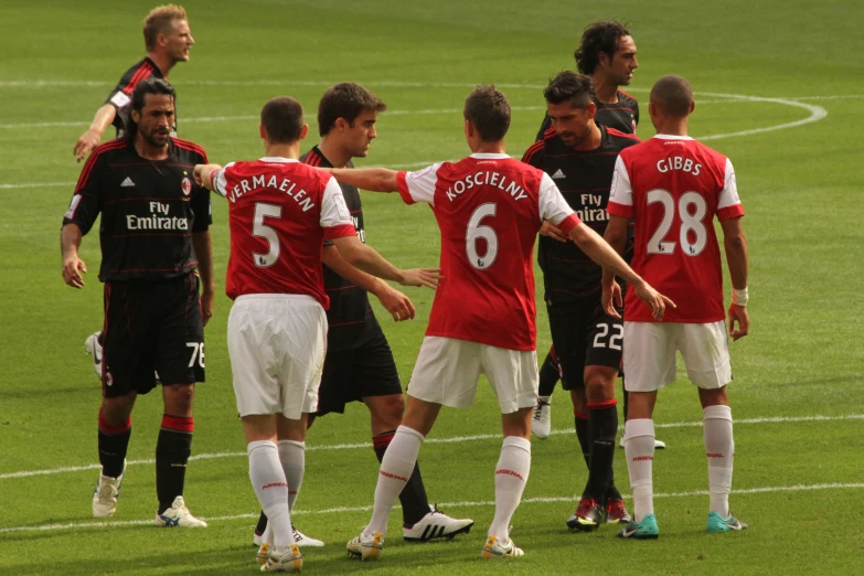 a group of men in uniforms playing soccer