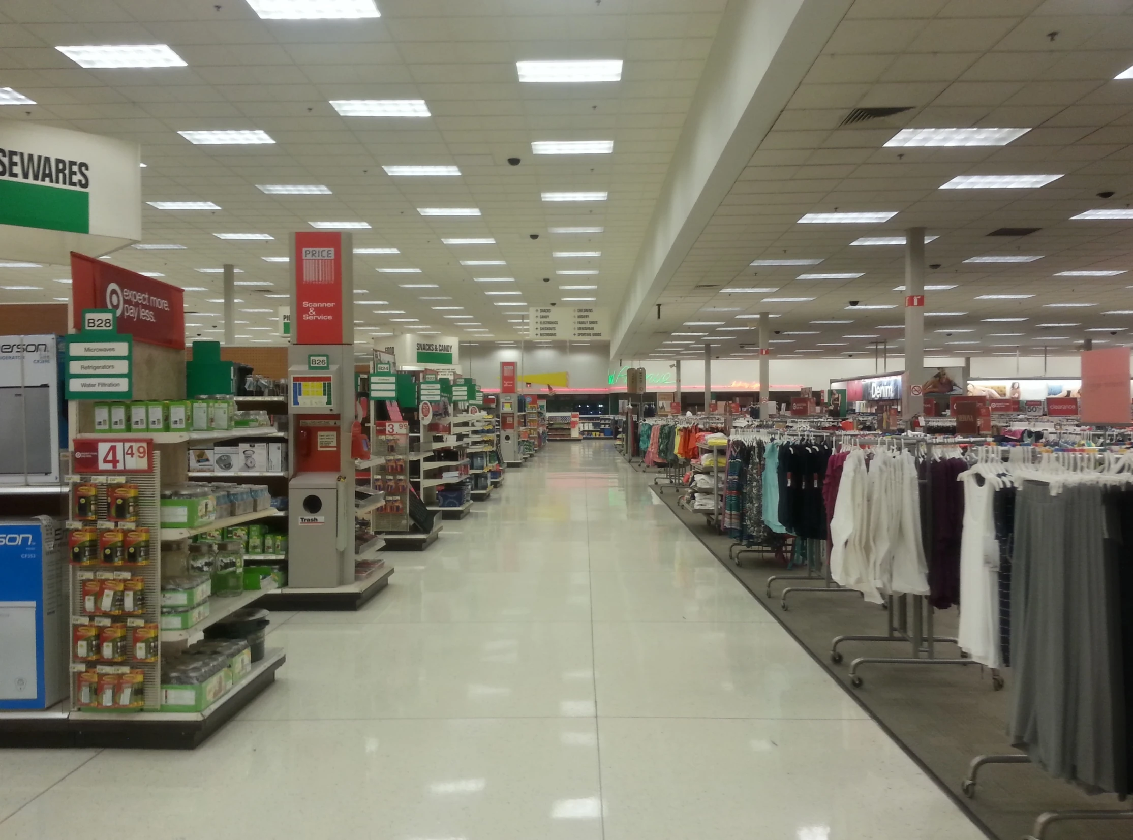 the aisle at a store that is filled with clothing