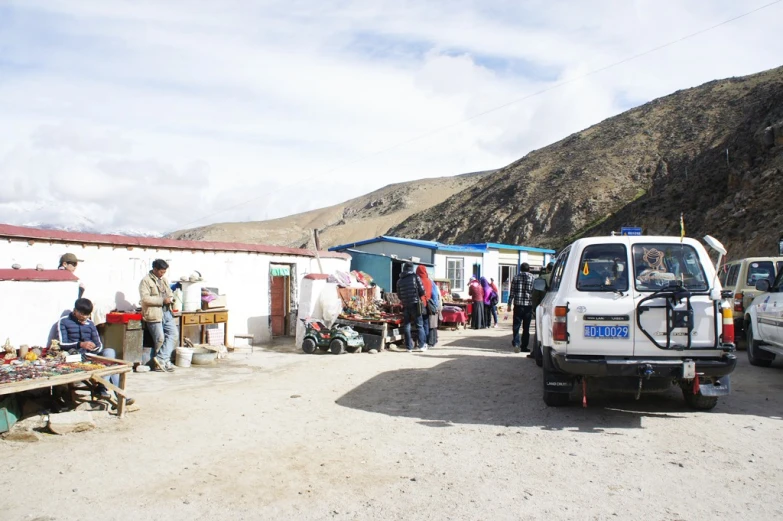 a man in a truck is parked by a white building