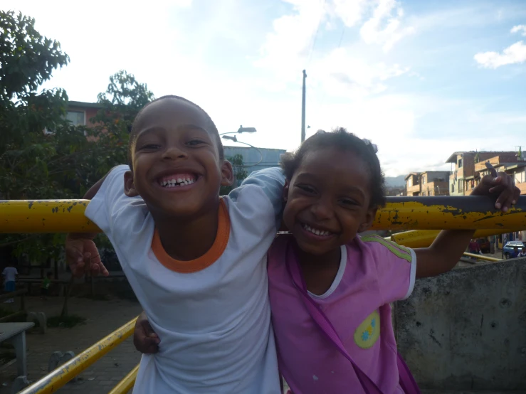 two young children standing in a playground at the park