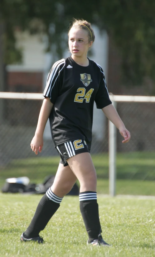 a female soccer player has just hit the ball