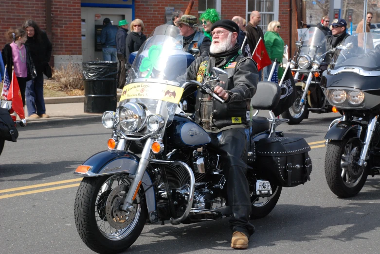 two guys riding on motorcycles together with irish flags