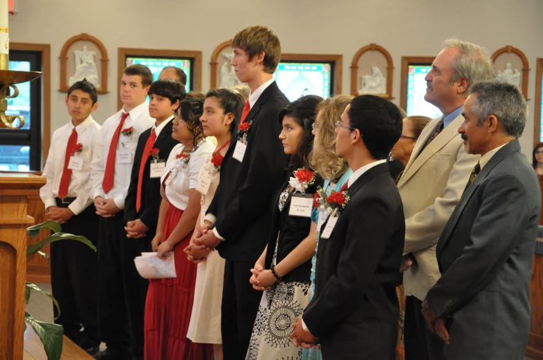 a group of people standing next to each other in front of a church