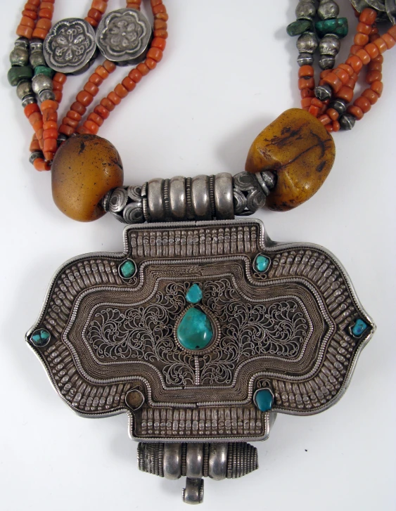 a necklace on a table with many beads and beads