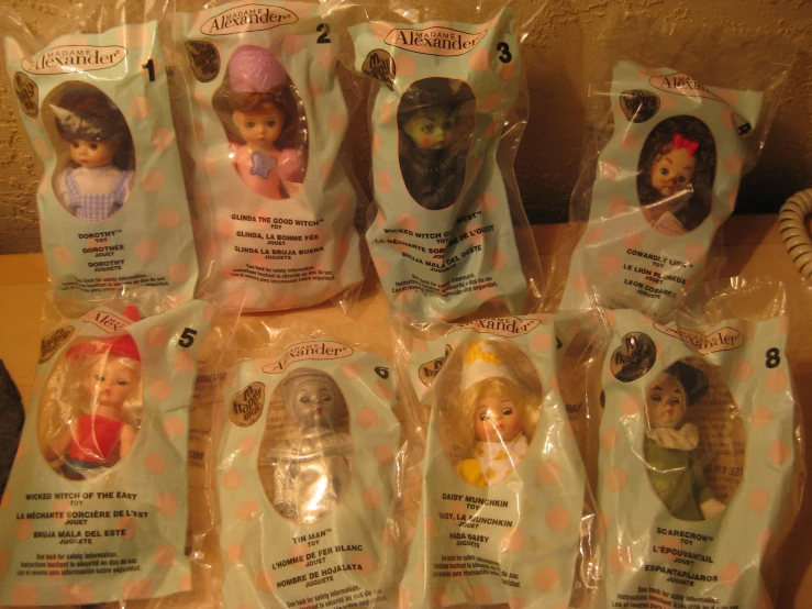 several packagings with small dolls in them on a table