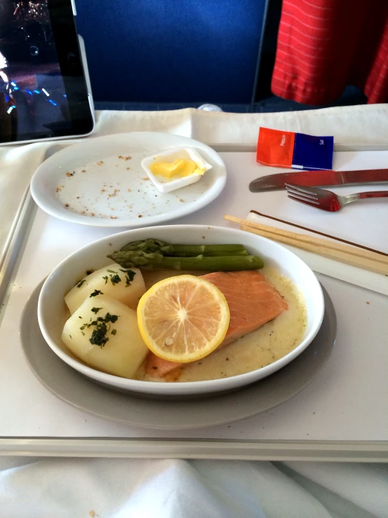 a tray with food on it including asparagus and potatoes