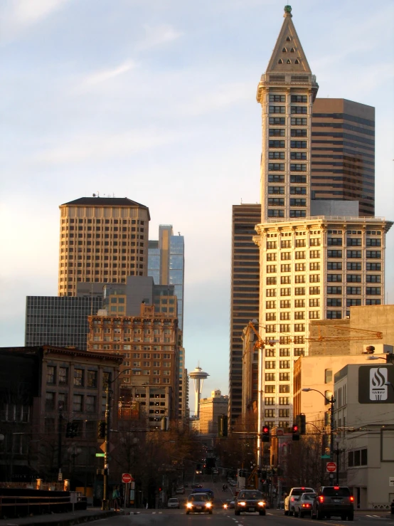 some very tall buildings and cars on a street