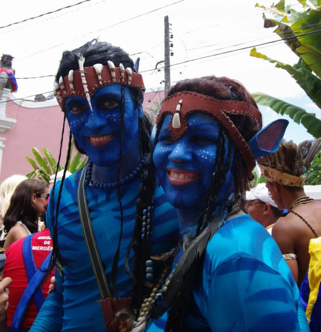 two people dressed in blue and brown with blue faces