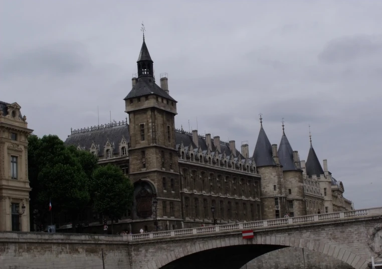 a clock tower rises over the old, historic buildings