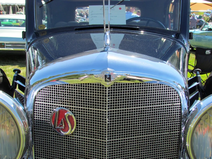 front end of classic old car displayed at outdoor event