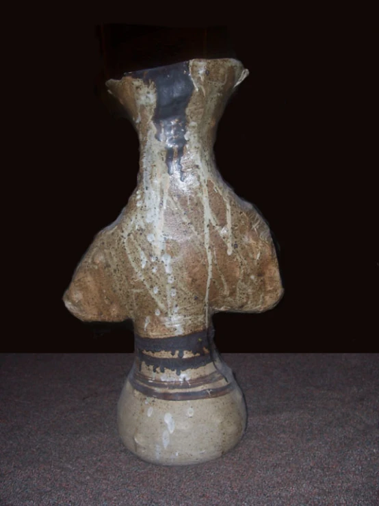 a very old, dirty, looking stone vase with it's base missing