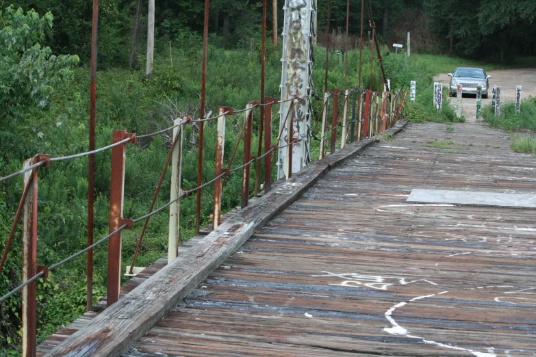 a truck is driving down a wooden path