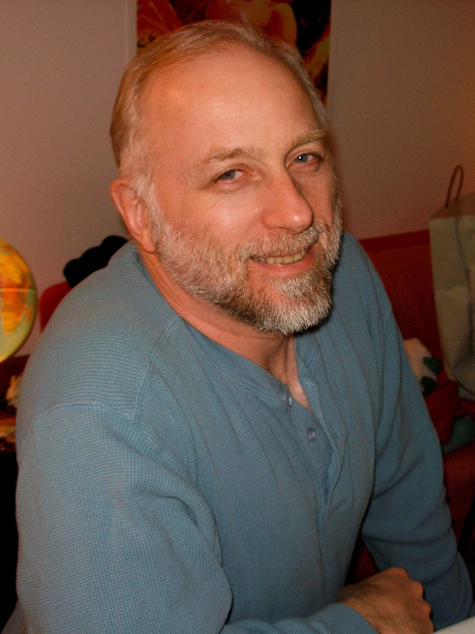 a man is sitting at a table and smiles