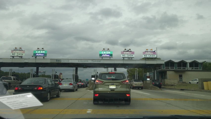 many cars traveling on the road below a sign for exit