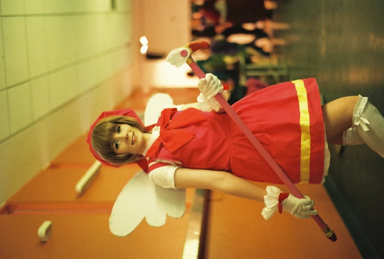 a woman with wings wearing a red costume