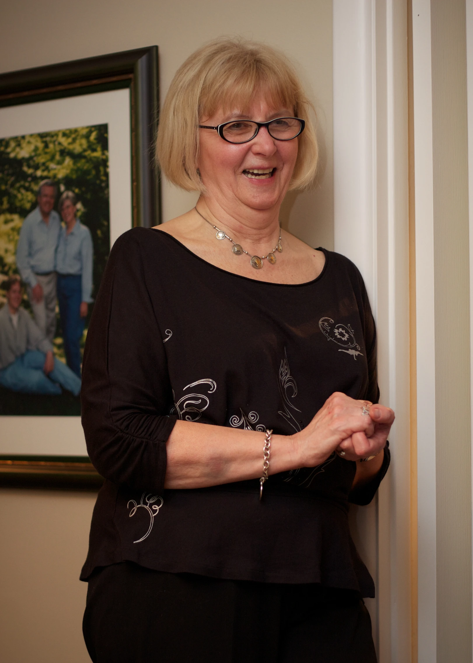 an older woman smiling and looking into a door