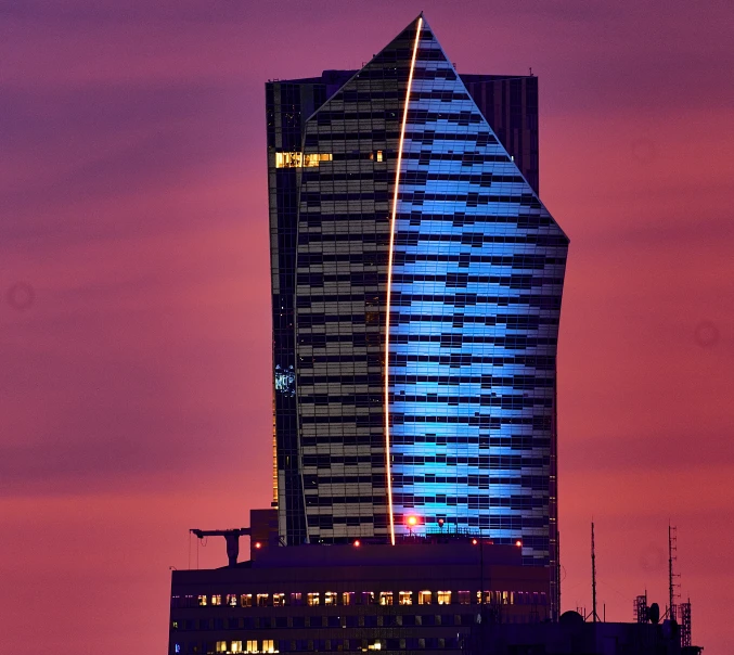 an image of the top of a building lit up in blue