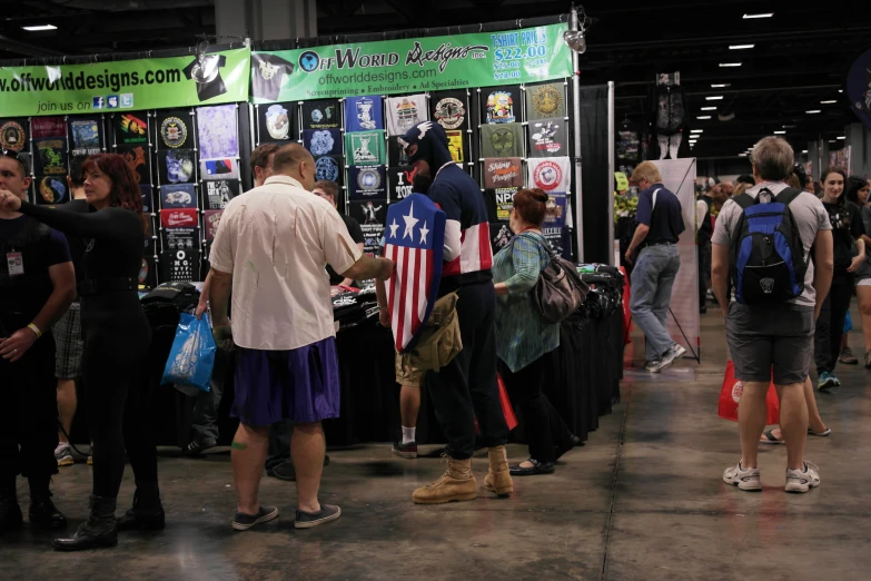 many people are looking at booths displaying items