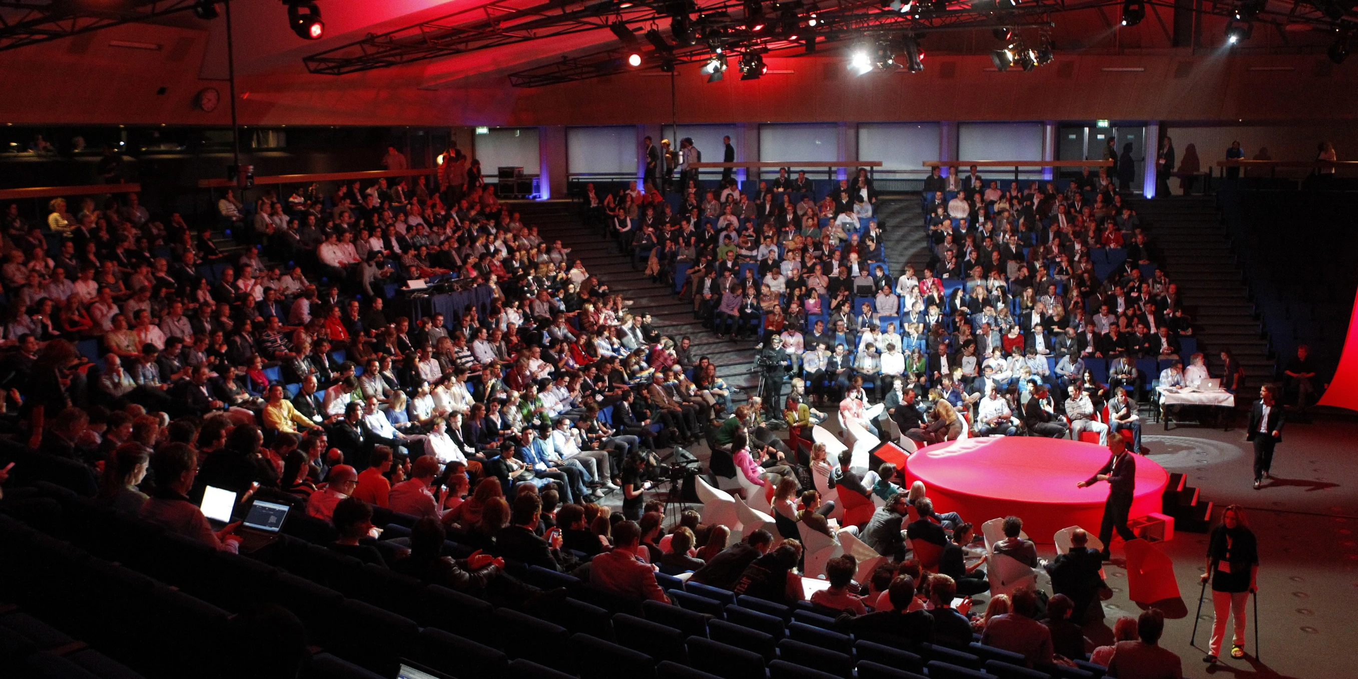 an audience at a conference in a large auditorium