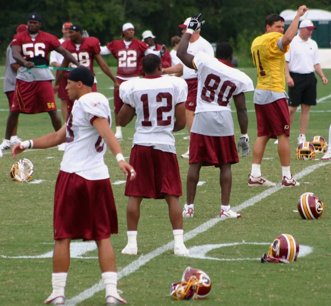 several men wearing uniforms are standing next to each other on a field