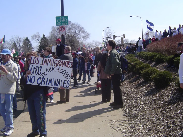 a group of people protesting outside on a sunny day