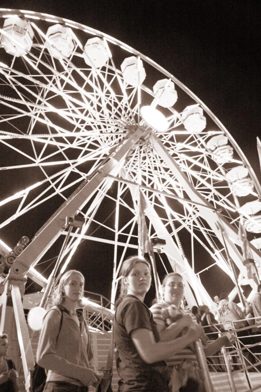 a group of people standing next to each other at a carnival